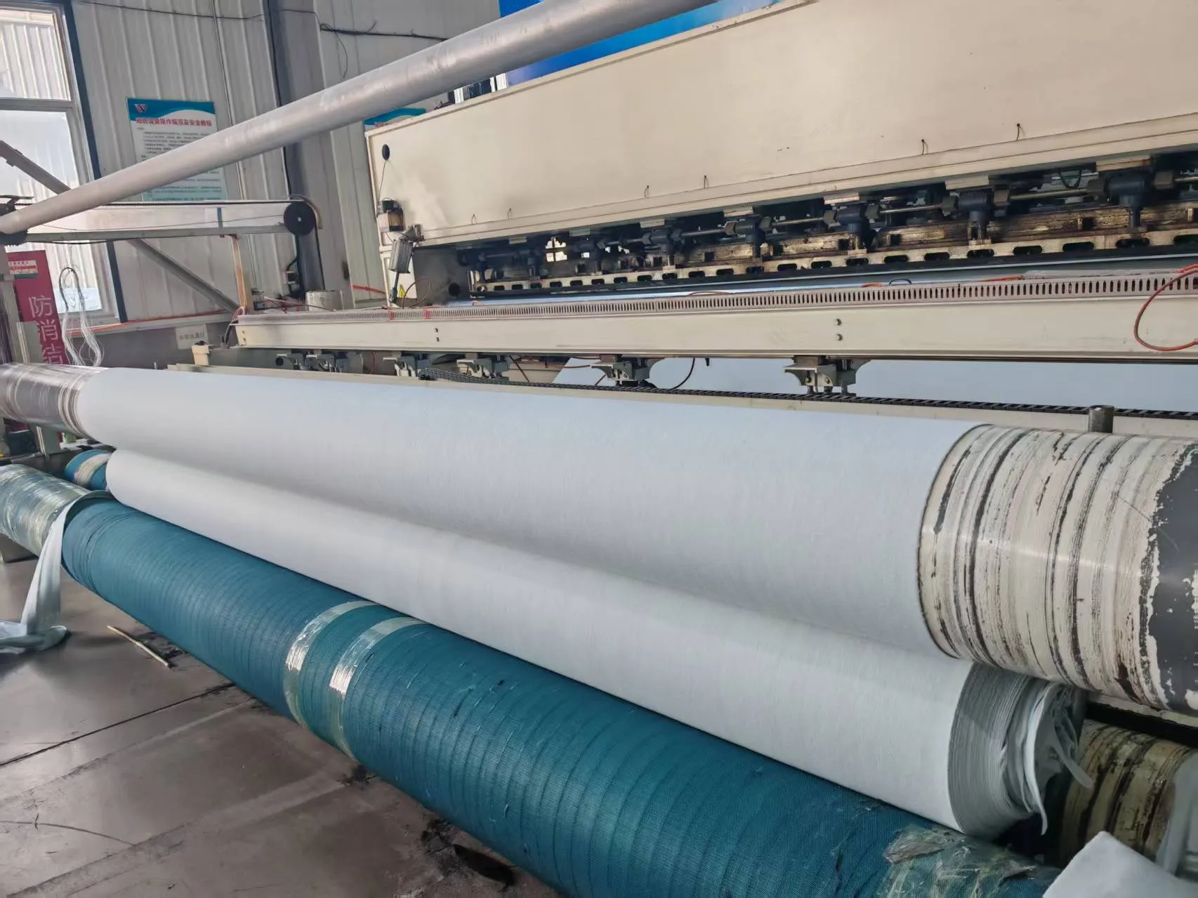 Needle-punch line producing continuous filament geotextile.